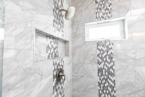 grey shower with black horizontal patterned tile